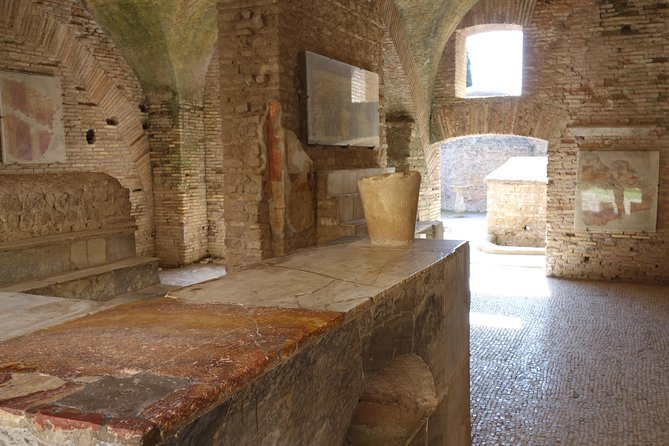 Ancient Ostia Antica Semi-Private Day Trip from Rome by Train with Guide - The amphitheater, temples, and Forum of the Corporations