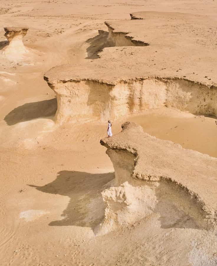 From Doha: Day Trip to North And West Qatar With Pickup - Zekreet changes the mood from heritage to open desert