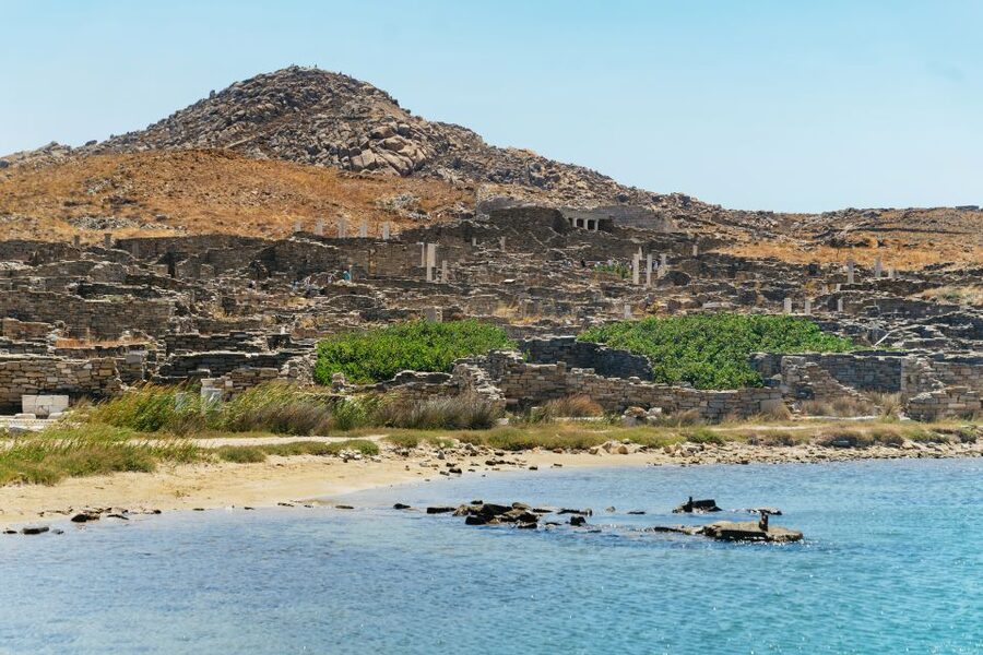 Mykonos Town: Archaeological Site of Delos Guided Day Trip - Following the guide through the ancient city