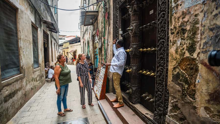 Zanzibar: Stone Town, Spice Tour, Prison Island with Lunch - Stone Town: doors, markets, palaces, and hard history
